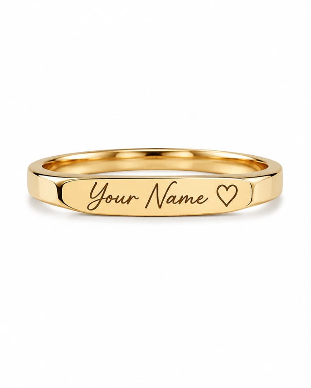 Gold-tone bar ring with a flat engraved plate reading “Your Name” beside a small heart