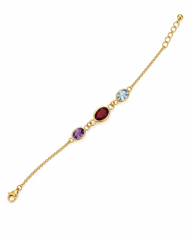 Fine gold-tone chain bracelet with three bezel-set oval stones — purple, deep red and pale blue